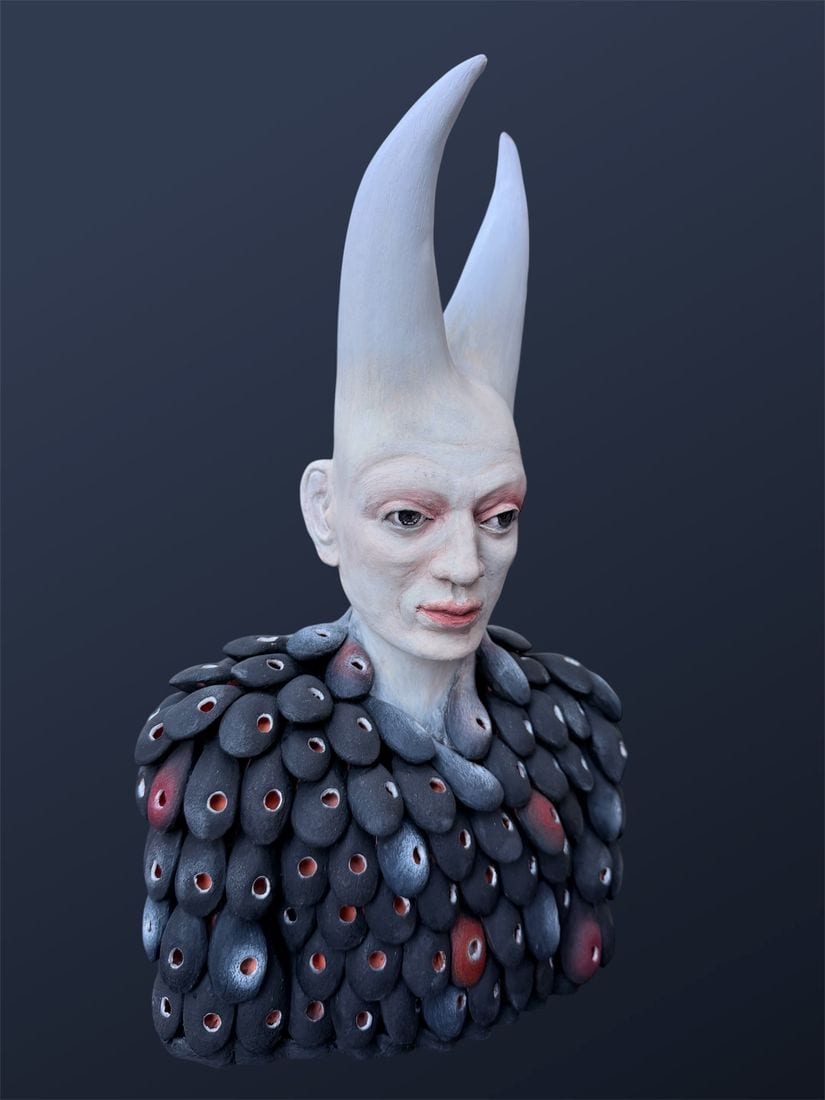 Armor, a ceramic bust by Ireri Krueger of a pale figure with two long white horns and a torso clad in dark, red-flecked scales