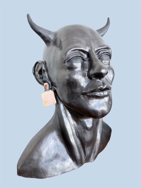 Faun, a glossy black ceramic bust by Ireri Krueger of a horned figure with a calm, knowing expression