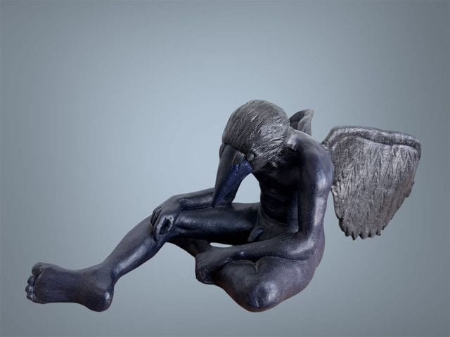 Fledgling, a ceramic sculpture by Ireri Krueger of a dark crouching figure with a bird's head and a single folded wing